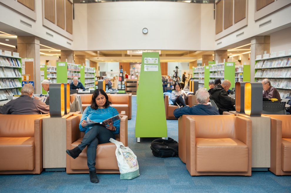 Patrons sitting in the magazine and newspaper area at the Bob Prittie Metrotown Branch