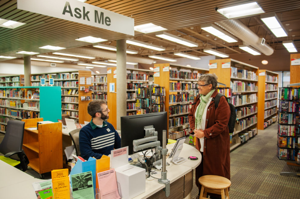 Person requesting help from staff at Cameron Branch information desk Person requesting help from staff at Cameron Branch information desk